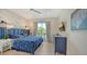 Nautical-themed bedroom with blue bedding and a private balcony at 421 Pine Ave, Anna Maria, FL 34216