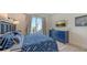 Nautical-themed bedroom with blue bedding and private balcony access at 421 Pine Ave, Anna Maria, FL 34216