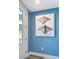 Bright entryway with coastal-themed art and light flooring at 421 Pine Ave, Anna Maria, FL 34216