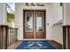 Elegant double front doors with a welcoming doormat at 421 Pine Ave, Anna Maria, FL 34216