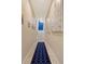 Bright hallway with geometric patterned rug leading to staircase at 421 Pine Ave, Anna Maria, FL 34216