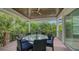 Relaxing outdoor deck with glass-top table and wicker chairs at 421 Pine Ave, Anna Maria, FL 34216