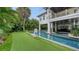 Resort-style backyard oasis with pool, spa, and putting green at 421 Pine Ave, Anna Maria, FL 34216