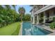 Inviting pool with spa, covered patio, and lush landscaping at 421 Pine Ave, Anna Maria, FL 34216