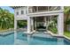 Relaxing pool and spa with ample lounge space under covered patio at 421 Pine Ave, Anna Maria, FL 34216