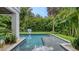 Relaxing pool area with putting green and tropical landscaping at 421 Pine Ave, Anna Maria, FL 34216