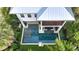 Aerial view of the refreshing pool with surrounding landscaping at 421 Pine Ave, Anna Maria, FL 34216