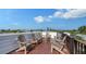 Rooftop deck with wooden chairs and a view of the neighborhood at 421 Pine Ave, Anna Maria, FL 34216