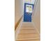 Modern staircase with a blue chevron accent wall and a geometric light fixture at 421 Pine Ave, Anna Maria, FL 34216