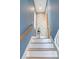 Modern stairs with wood and white accents at 421 Pine Ave, Anna Maria, FL 34216