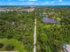 Aerial view of community with lush landscape and pond at 4215 Breezeway Blvd # 2420, Sarasota, FL 34238