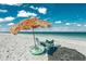 Relaxing beach setup with chairs and umbrella at 4215 Breezeway Blvd # 2420, Sarasota, FL 34238