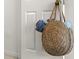 A straw tote bag hangs on a bedroom door at 4215 Breezeway Blvd # 2420, Sarasota, FL 34238