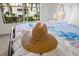 Close-up of a straw hat on a bedspread at 4215 Breezeway Blvd # 2420, Sarasota, FL 34238