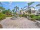 Exterior view of condo building with courtyard fountain and lush landscaping at 4215 Breezeway Blvd # 2420, Sarasota, FL 34238