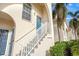 Inviting condo exterior featuring a blue front door and white railings at 4215 Breezeway Blvd # 2420, Sarasota, FL 34238