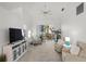 Relaxing living area with two armchairs, a large TV, and access to balcony at 4215 Breezeway Blvd # 2420, Sarasota, FL 34238