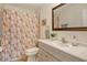 Simple bathroom with floral shower curtain and a vanity with white cabinets at 4302 Madeira Ct # 3334, Sarasota, FL 34233