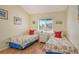 Twin bedroom with two beds, window, and colorful bedding at 4302 Madeira Ct # 3334, Sarasota, FL 34233