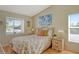 Bedroom with two windows, wood floors, and a decorative bedspread at 4302 Madeira Ct # 3334, Sarasota, FL 34233