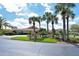 Community clubhouse with palm trees and a paved driveway at 4302 Madeira Ct # 3334, Sarasota, FL 34233