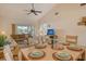 Dining area with light wood table and chairs, overlooking living room at 4302 Madeira Ct # 3334, Sarasota, FL 34233