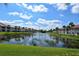 Serene lake view with lush landscaping and condo buildings at 4302 Madeira Ct # 3334, Sarasota, FL 34233