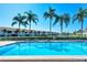 Refreshing community pool with palm trees and residential buildings in the background at 4302 Madeira Ct # 3334, Sarasota, FL 34233