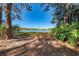 Park bench overlooking a tranquil lake, framed by trees at 4364 Brandywine Dr, Sarasota, FL 34241