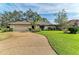 Single-story home with a large front yard, attached garage, and manicured landscaping at 4364 Brandywine Dr, Sarasota, FL 34241