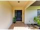 Inviting front entry with a black door and potted plants at 4364 Brandywine Dr, Sarasota, FL 34241