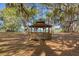 Wooden gazebo shaded by moss-draped oak trees near a lake at 4364 Brandywine Dr, Sarasota, FL 34241