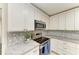 Bright kitchen with stainless steel range and white cabinets at 4364 Brandywine Dr, Sarasota, FL 34241