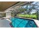 Inviting screened pool and spa with a view of lush landscaping at 4364 Brandywine Dr, Sarasota, FL 34241