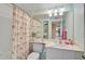 Bright bathroom with flamingo-themed shower curtain, vanity, and ample storage at 4705 Sand Trap Street E Cir # 105, Bradenton, FL 34203