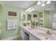 Bright bathroom features a large mirror and a white single sink at 4705 Sand Trap Street E Cir # 105, Bradenton, FL 34203