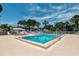 A refreshing community pool with plenty of lounge chairs surrounded by tropical palm trees at 4705 Sand Trap Street E Cir # 105, Bradenton, FL 34203