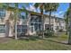 Rear exterior view of the condo featuring screened in lanais and lush landscaping at 4705 Sand Trap Street E Cir # 105, Bradenton, FL 34203