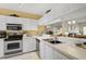 Well-lit kitchen with white cabinets, stainless steel appliances, and mirrored backsplash at 4705 Sand Trap Street E Cir # 105, Bradenton, FL 34203