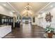 Interior shot showcasing a spacious lobby with elegant chandeliers, hardwood floors, and reception area at 4705 Sand Trap Street E Cir # 105, Bradenton, FL 34203