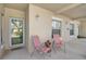 A welcoming front patio with seating and a glass front door at 4705 Sand Trap Street E Cir # 105, Bradenton, FL 34203