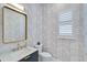 Modern bathroom with geometric patterned tile and gold fixtures at 4940 Surfside Cir, Bradenton, FL 34211