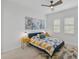 Spacious bedroom with blue bedding, ceiling fan and window shutters at 4940 Surfside Cir, Bradenton, FL 34211