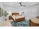 Relaxing bedroom with wooden bed frame, and blue floral rug at 4940 Surfside Cir, Bradenton, FL 34211