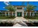 Community center entrance with landscaping and palm trees at 4940 Surfside Cir, Bradenton, FL 34211