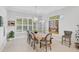 Bright dining room features a rustic table, chandelier, and plantation shutters at 4940 Surfside Cir, Bradenton, FL 34211