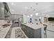 Modern kitchen with gray cabinets, granite counters, and stainless steel appliances at 4940 Surfside Cir, Bradenton, FL 34211