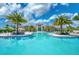 Community resort pool with palm trees and lounge chairs at 4940 Surfside Cir, Bradenton, FL 34211