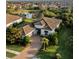 Stunning aerial view of a home featuring a tile roof, mature landscaping, and a serene pond at 5341 Greenbrook Dr, Sarasota, FL 34238