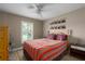 Spacious bedroom with hardwood floors, a ceiling fan, and large window at 5424 81St Avenue E Cir, Palmetto, FL 34221